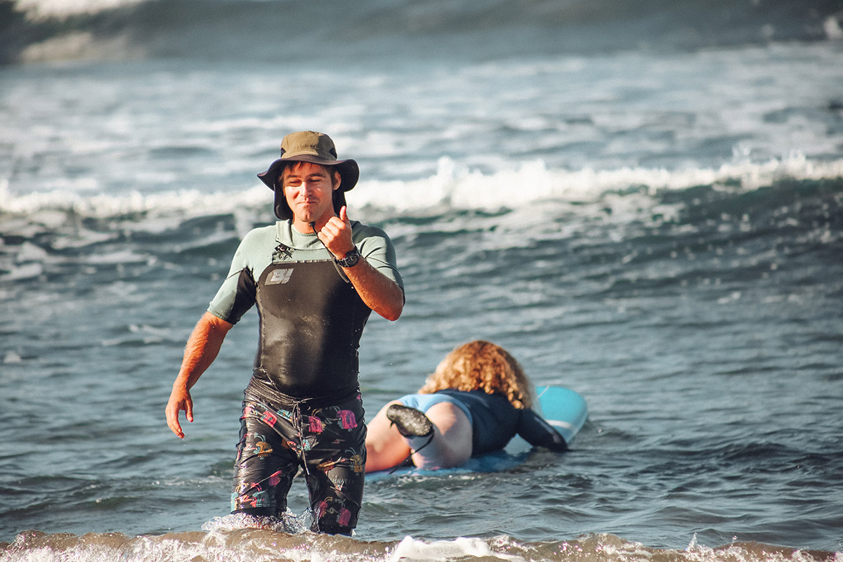 Surfer standing in the ocean near the shore